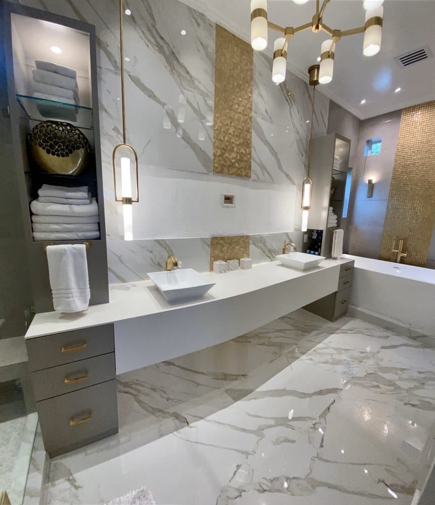 Luxury master bathroom with floating vanity, marble walls, and gold accents